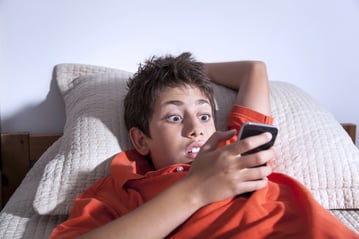 StudentOnPhoneInHotel.jpg